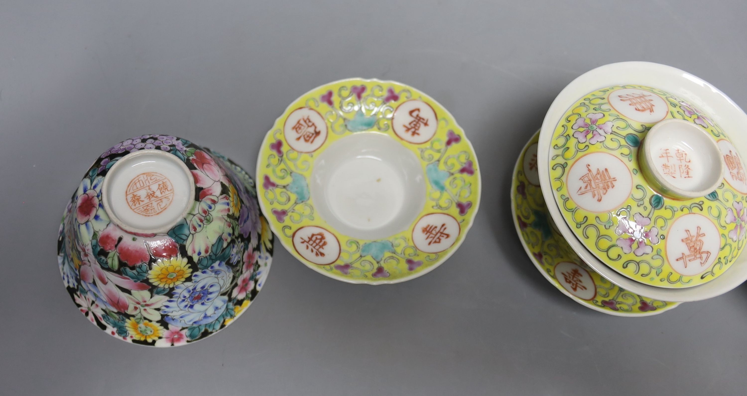A pair of Chinese enamelled porcelain rice bowls, covers and stands and an odd bowl